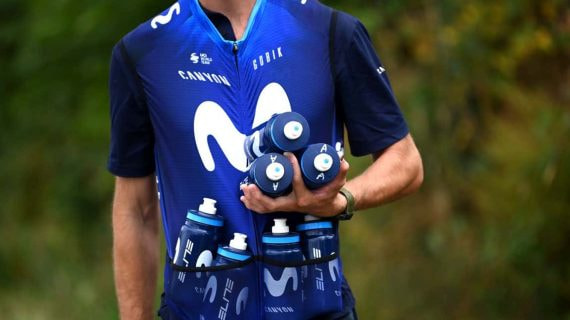Un auxiliar del equipo Movistar espera para proporcionar bidones a sus ciclistas.