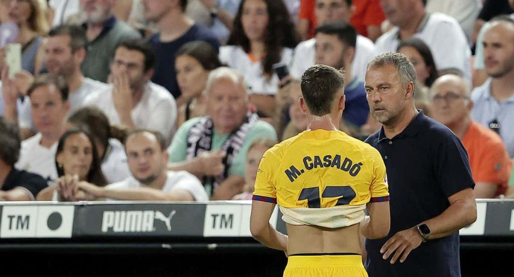 Marc Casadó junto a Hansi Flick durante un encuentro de LaLiga.