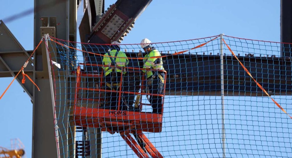 Dos obreros trabajan en los exteriores del Camp Nou.