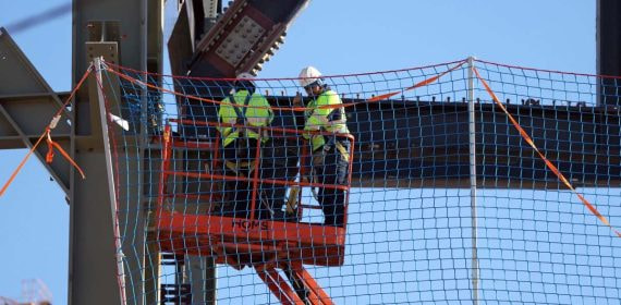 Dos obreros trabajan en los exteriores del Camp Nou.