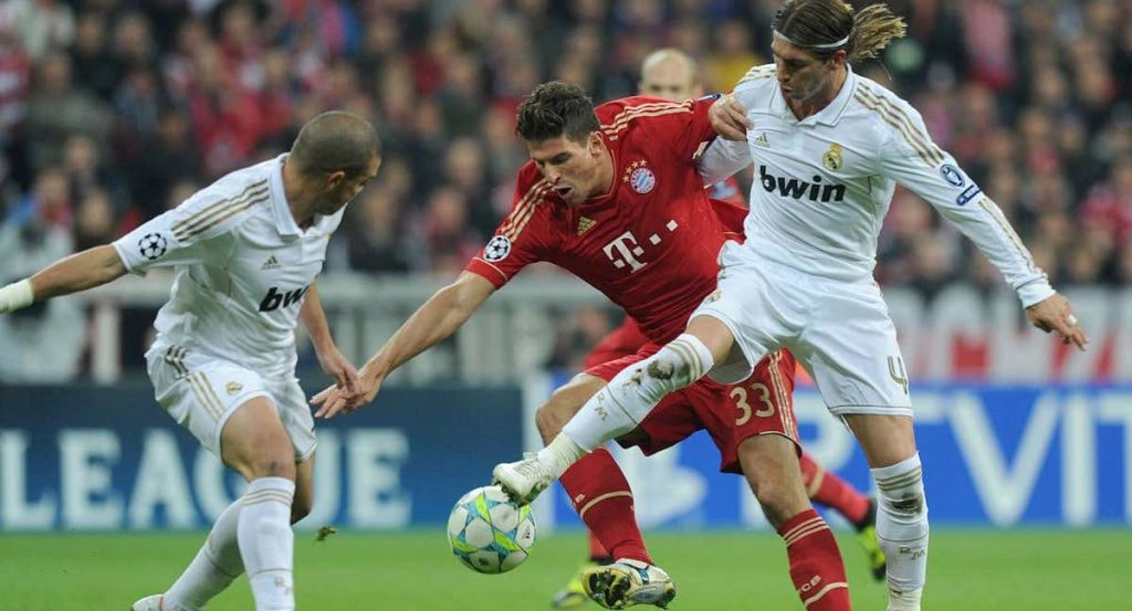 Mario Gómez puja por un balón contra Pepe y Sergio Ramos en 2012.