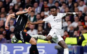 Vinicius intenta marcharse de Saliba en el Bernabéu.