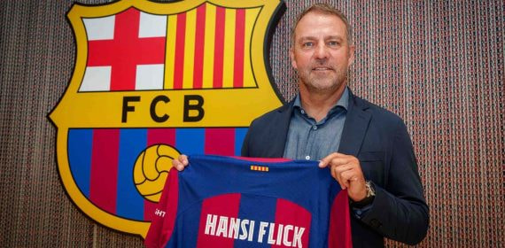 Hansi Flick posando con la camiseta del FC Barcelona el día de la firma.