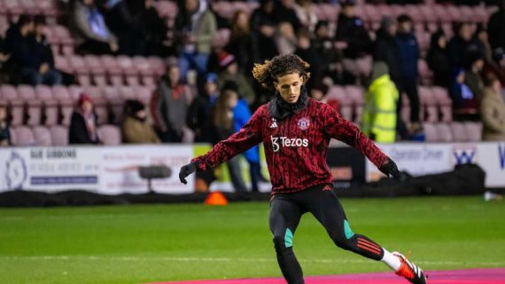 Hannibal Mejbri calienta antes de un partido con el Manchester United.