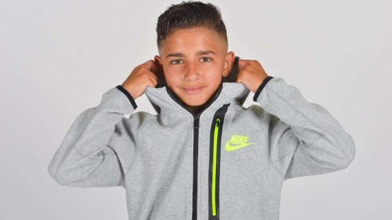 Yeremay, con 13 años de edad, posa sonriente con su nueva sudadera