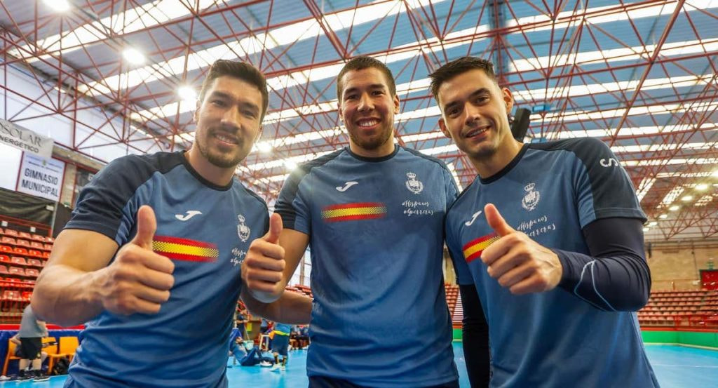 Álex y Dani Dujshebaev, junto a un compañero, posan con el pulgar en alto con la equipación azul de la selección española de balonmano