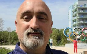 Sergi López, exnadador olímpico, se fotografía ante los anillos olímpicos de la Villa de los Juegos de París 2024