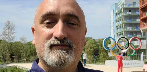 Sergi López, exnadador olímpico, se fotografía ante los anillos olímpicos de la Villa de los Juegos de París 2024