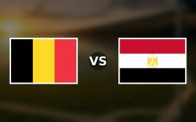 Banderas de Bélgica y Egipto enfrentadas sobre un campo de fútbol difuminado, pronóstico del Mundial 2026