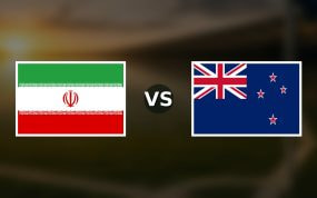 Banderas de Irán y Nueva Zelanda enfrentadas sobre un campo de fútbol difuminado, pronóstico del Mundial 2026
