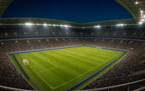 Estadio de fútbol lleno con los focos encendidos y el césped recién marcado antes de una jornada inaugural