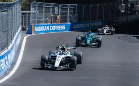 Un Williams blanco rueda por delante de un Aston Martin verde en una curva del circuito urbano del Madring, entre vallas