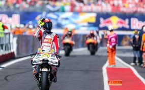 Fermín Aldeguer saluda a un aficionado en el parque cerrado del Gran Premio de San Marino de MotoGP