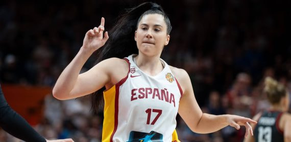 Megan Gustafson, con la camiseta blanca de España y el número 17, levanta un dedo en la pista durante un partido ante Alemania
